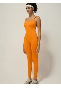 Close-up detail of high-elastic orange seamless yoga jumpsuit with thin shoulder straps