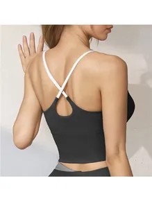 Detail of cross back straps and teardrop cutout on black high-impact sports bra