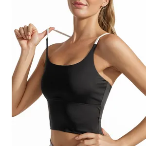 Women's high-impact sports bra with black body and white cross back straps on a model