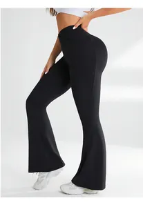 Close-up of high-waisted crossover V-waistband on black flared yoga pants for body shaping