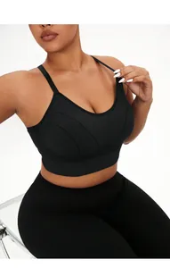 Detail of black cross-back yoga vest showing seamless stitching and wide ribbed hem