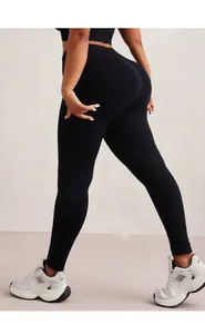 Detail of high waisted black sports leggings showing vertical knit texture and lifting cut