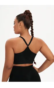 Macro view of women's black high-impact sports bra with cross-back adjustable straps