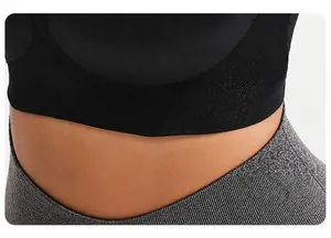Macro shot of the widened ribbed hemline on a black high-impact sports bra for stability