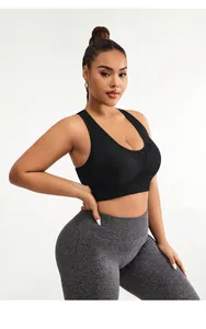Close-up of high-elasticity seamless fabric on plus size black sports bra and grey leggings