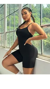 Close-up of black plus size yoga bodysuit featuring thin straps and elastic athletic fabric