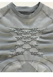 Detail of grey thermal compression top featuring striped patterns and breathable hollow mesh