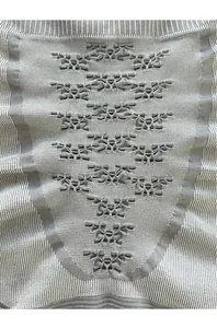 Detailed knit texture of grey thermal base layer with breathable butterfly pattern