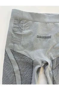Detail of high-elastic seamless grey thermal leggings with honeycomb compression texture