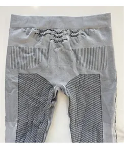 Flat lay of gray thermal leggings showing seamless honeycomb breathable texture and ribbed waist
