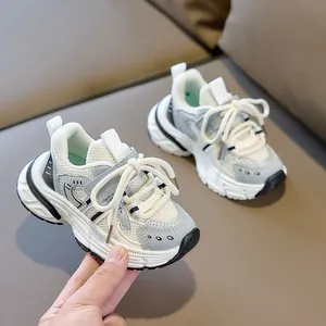 Close-up of breathable mesh and faux leather patches on these kids' chunky sneakers