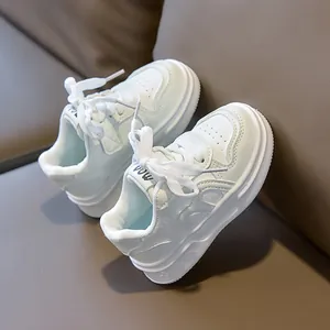 Detail view of children's white leather sneaker with embossed heart flower pattern and thick sole