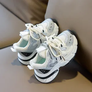 Top view of breathable mesh kids sneakers with anti-slip thick soles on brown leather