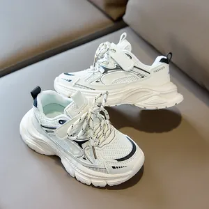 Close-up of white breathable mesh kids' sneakers with velcro and chunky soles