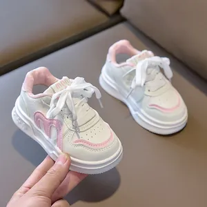 Close-up of pink and white children shoes with soft leather texture and nonslip thick soles