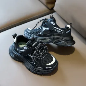 Detail of kids black chunky sneakers showing breathable mesh upper and velcro strap