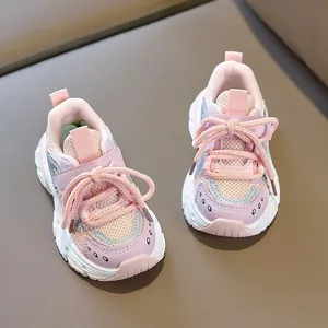 Detail of pink and blue breathable mesh fabric and anti-slip sole on kids sports shoes
