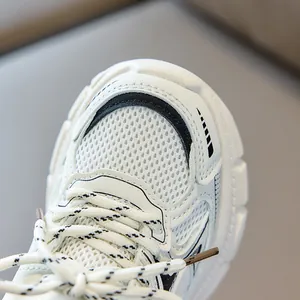 Detailed macro view of white breathable mesh upper and stitching on kids retro daddy shoes