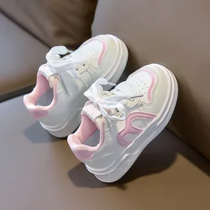 Detail view of pink stars and clover embossing on the white sole of kids sneakers