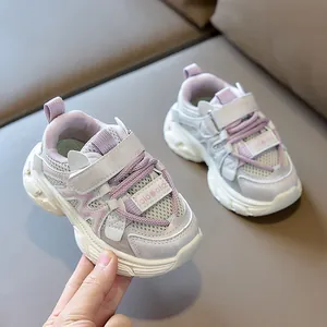 Detail of children's mesh sneakers with purple accents and breathable texture