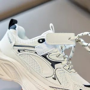 Macro detail of breathable white mesh, velcro strap, and thick sole on kids sneakers