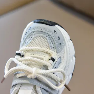 Detailed macro view of breathable mesh upper and reinforced rubber toe on kids sneakers