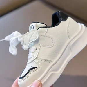 Close-up of kids cream sneakers with velcro strap and non-slip white rubber sole