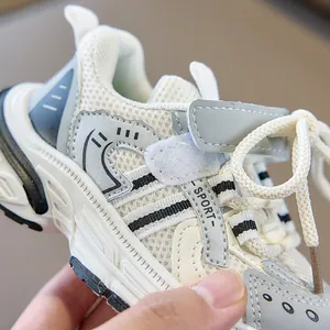 Detail of mesh kids sneakers featuring drawcord laces and secure hook-and-loop closure