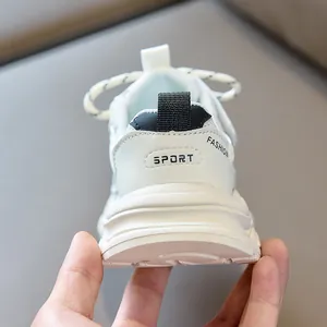 Detailed back view of white children's sneakers with SPORT lettering and pull tab