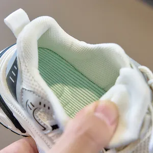 Detailed macro view of breathable mesh lining and vibrant green anti-slip insole of kids sneakers