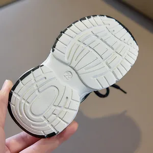 Detailed view of non-slip rubber sole with texture and size 23 mark on kids sneakers