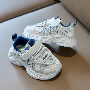 Detailed close-up of breathable mesh fabric and blue leather patches on kids sneakers
