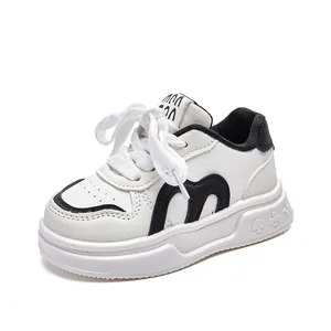 Classic white leather kids sports sneakers with velcro straps and playing card sole patterns