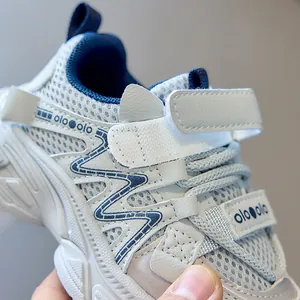 Detail of breathable mesh and synthetic leather on kids' sports shoes with Velcro strap