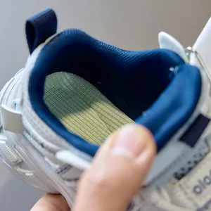 Close-up of breathable mesh insole and padded collar of white kids sports sneakers