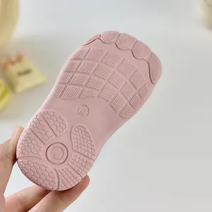Détail d'une chaussure bébé rose montrant la semelle en caoutchouc antidérapante