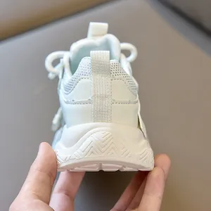 Detail of white kids sneakers showing the heel pull tab and wavy non-slip sole texture