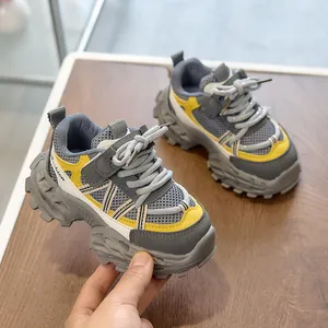 Detail of kids breathable mesh sneaker featuring gray-yellow panels and non-slip sole