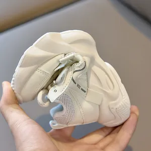 Close-up of flexible soft sole on white kids sneakers showing superior bending durability