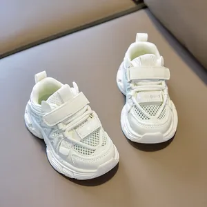 Detail of white kids' sports shoes with breathable mesh and Velcro strap closure