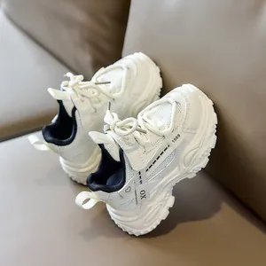 Detail of white children's sneakers with mesh panels and adjustable strap closure