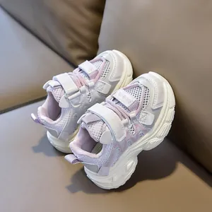Detail of purple breathable mesh kids sneakers with Velcro strap and thick EVA sole