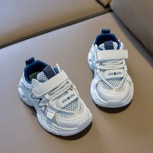 Detail of breathable mesh upper and durable Velcro strap on children's cream running shoes