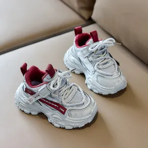 Macro detail of breathable mesh fabric and grey synthetic leather on children sneakers