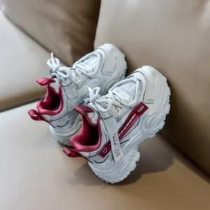 Detail of kids sporty sneakers featuring leather mesh patchwork and 1989 embroidery