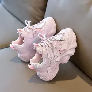 Detail of pink kids sneaker with breathable mesh, thick sole and fashion text