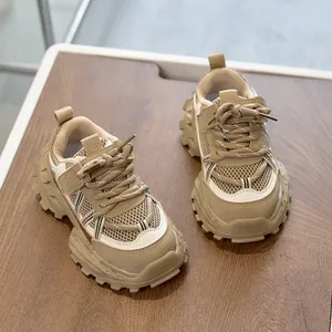 Detailed macro view of the breathable mesh upper and durable thick gear sole on kids' sneakers