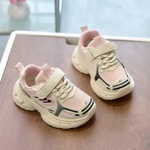 Detail view of pink and beige kids sneakers with breathable mesh and velcro straps