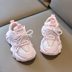 Detail of pink children's sneakers with mesh panels and adjustable velcro straps