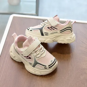 Macro detail of breathable mesh and faux leather on pink and beige kids' sneakers